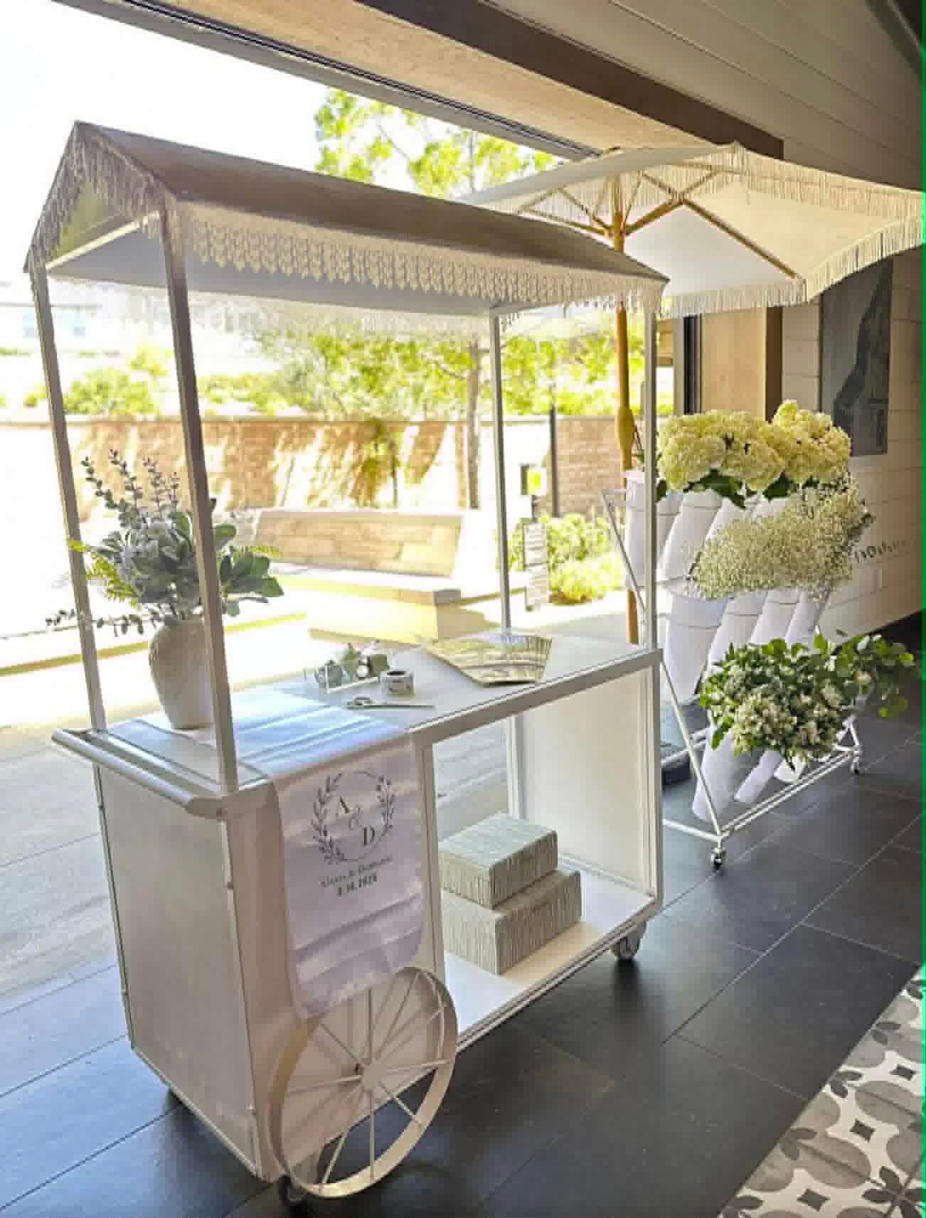 Elegant white flower cart with hydrangeas for wedding