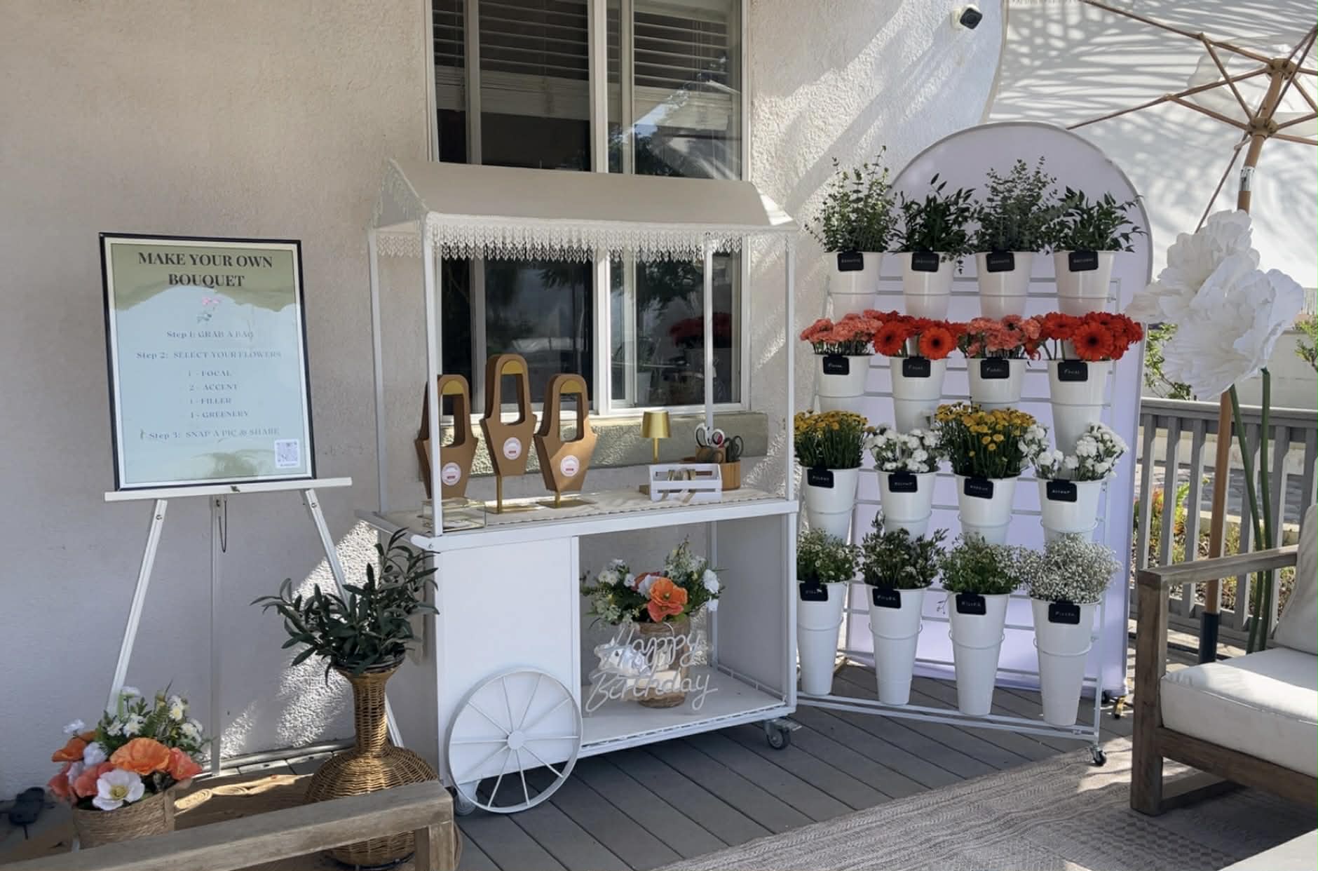 Flower bar cart with colorful blooms and make your own bouquet sign