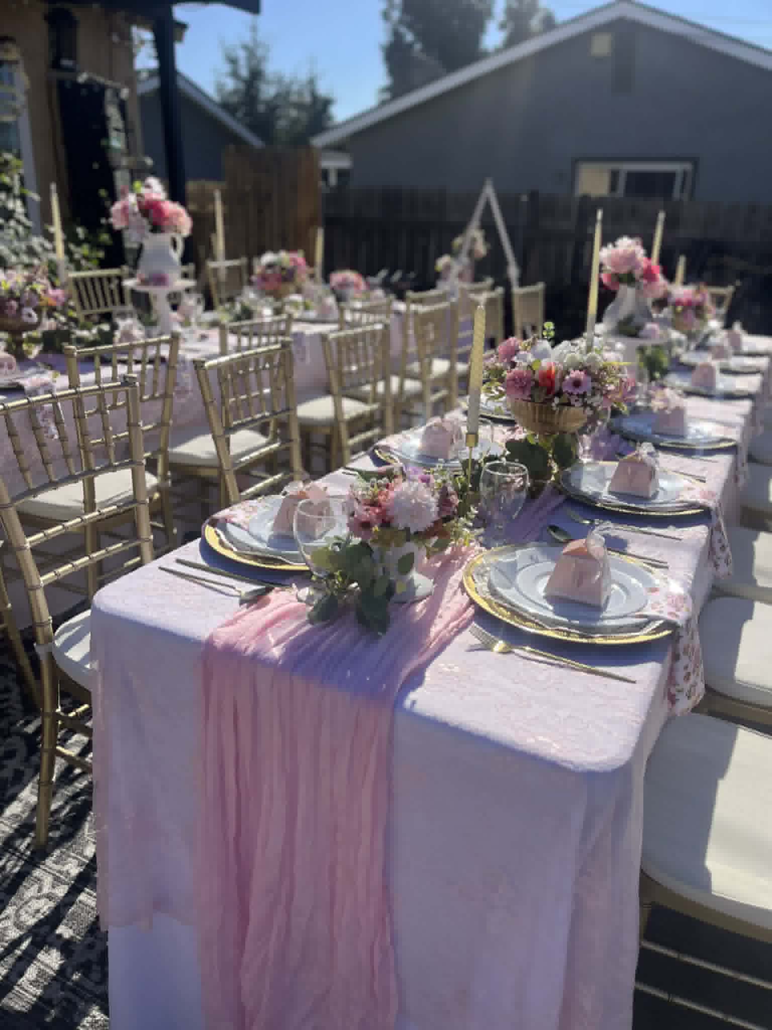 Pink garden party close-up tablescape with gold chiavari chairs