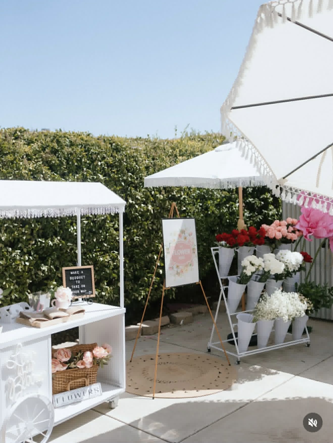Outdoor flower bar with white market stalls and fresh blooms