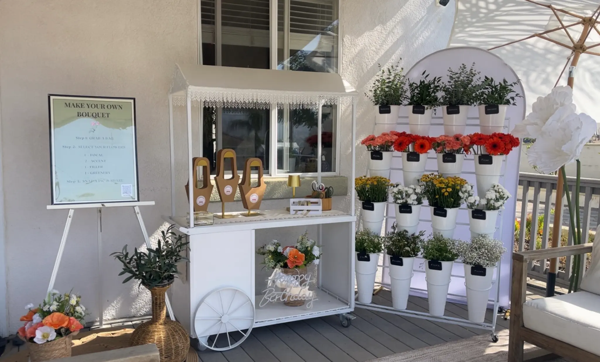 Outdoor flower bar birthday setup with colorful blooms